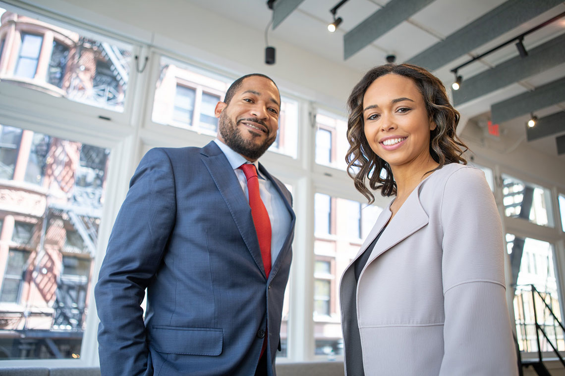 A man in a grey suit and a woman in a grey jacket offer ethical consumer collection services