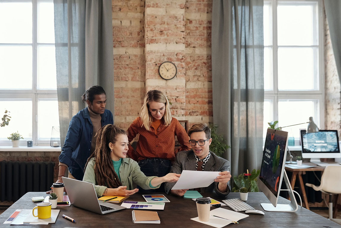 A group of young business people hold a meeting to plan branding and reputation