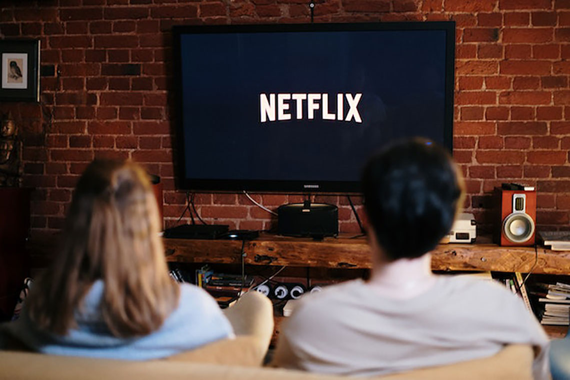 people watching netflix on a couch