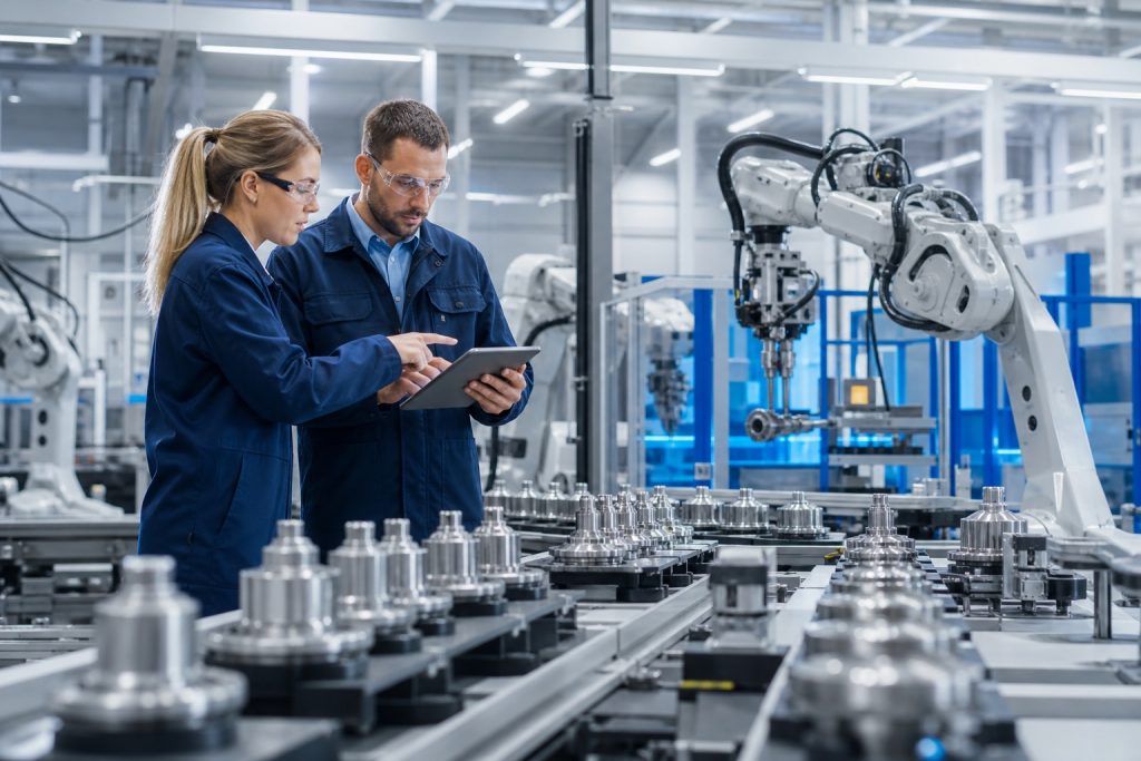 Manufacturing technicians reviewing an automated production line