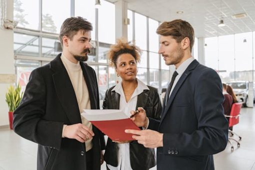 agent handles a car lease with a man and woman