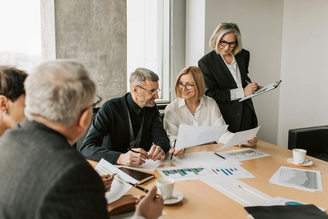 business leader poring over charts in a board meeting