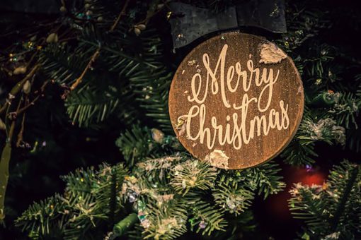 christmas ornamed on a tree saying merry christmas
