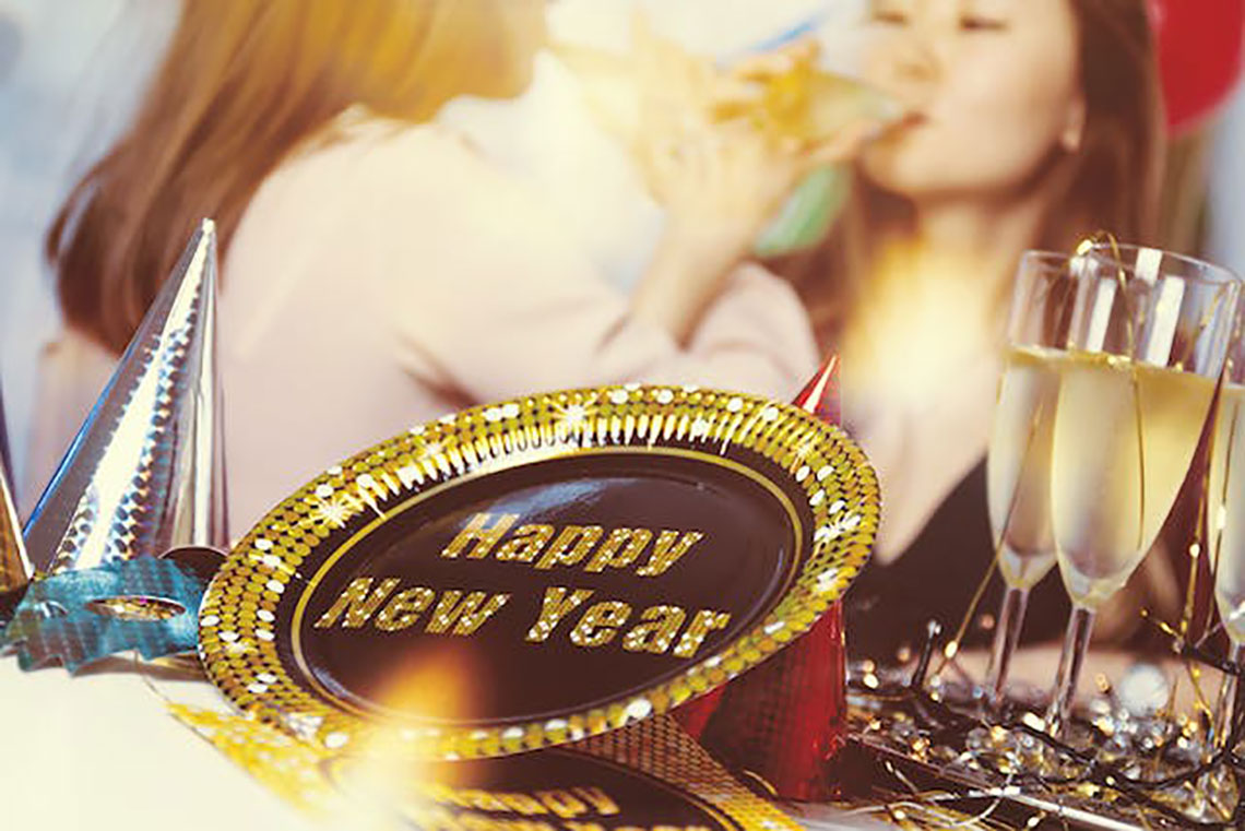 women drinking champagne with new years decorations